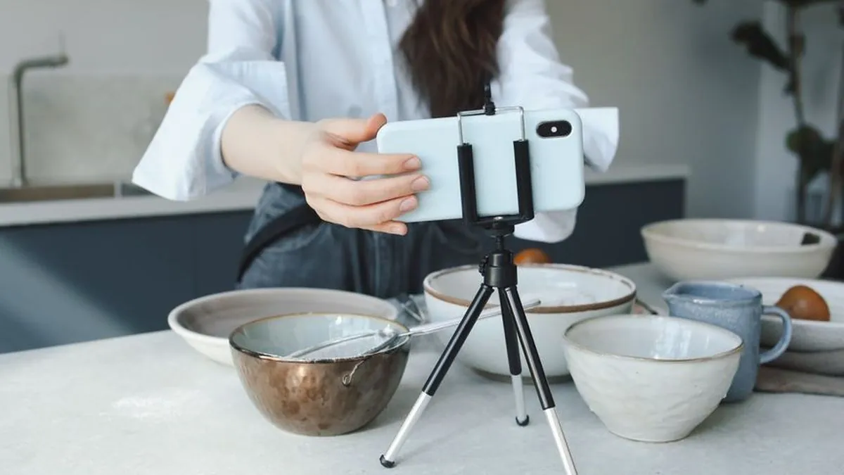 Smartphone on a small tripod filming a short video in a kitchen