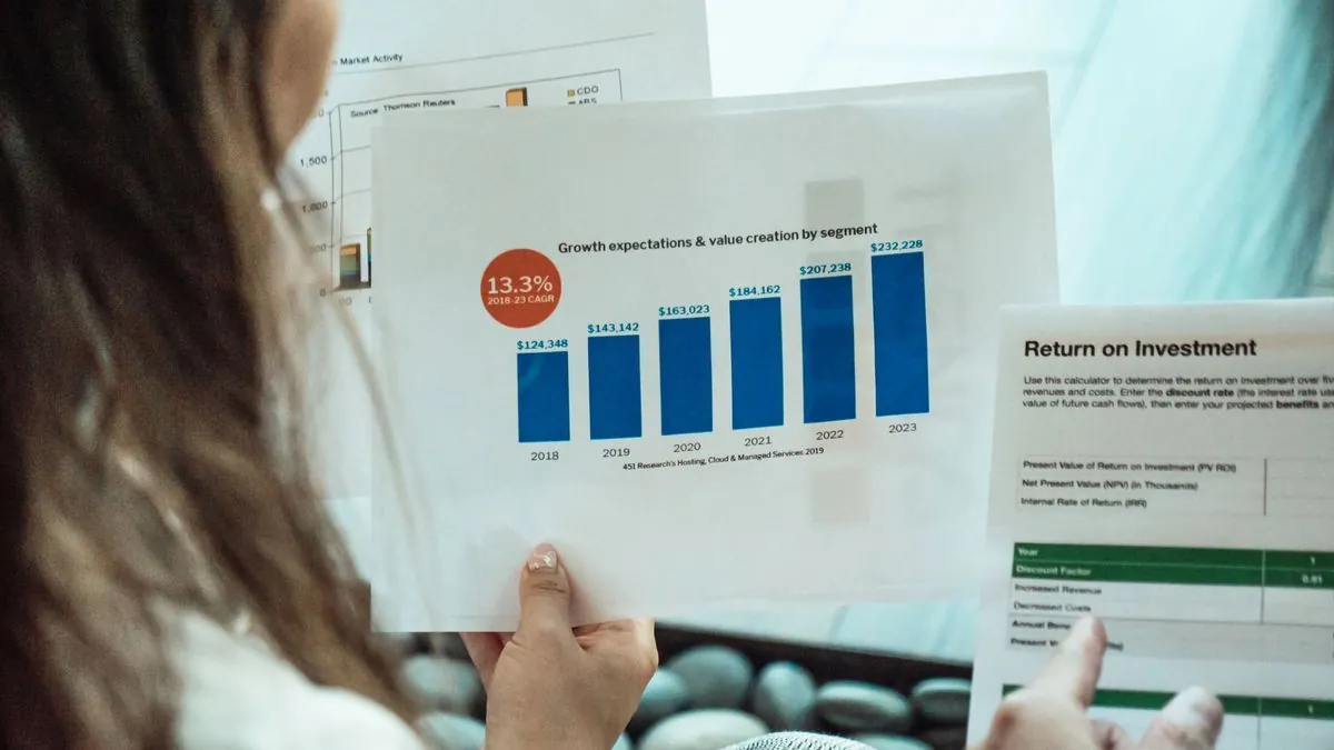 Business professionals reviewing marketing performance reports and growth charts on a laptop