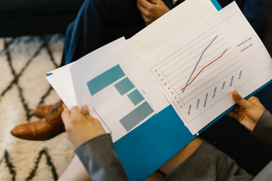 Business owner reviewing financial reports and digital marketing results at a desk