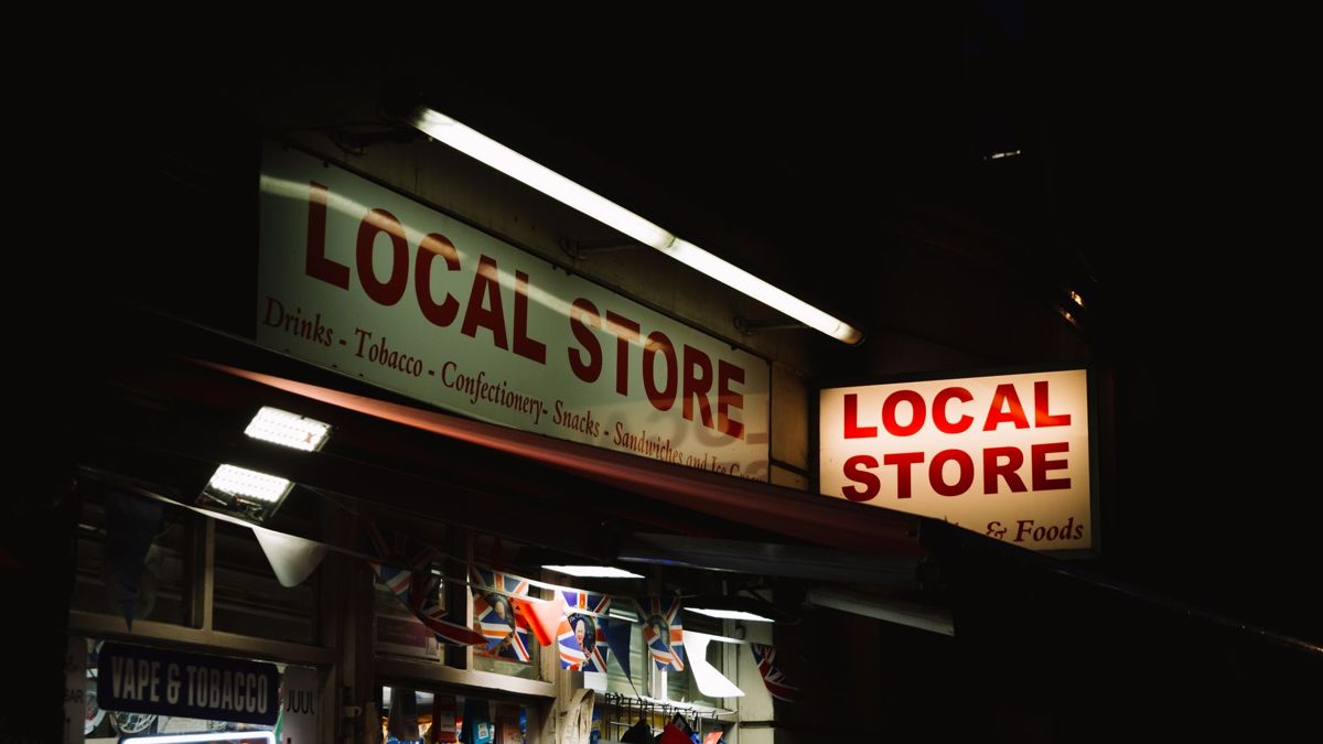 Illuminated local store signboard at night