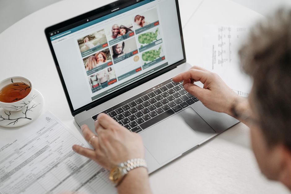 Business owner searching on a laptop to learn about answer engine optimization
