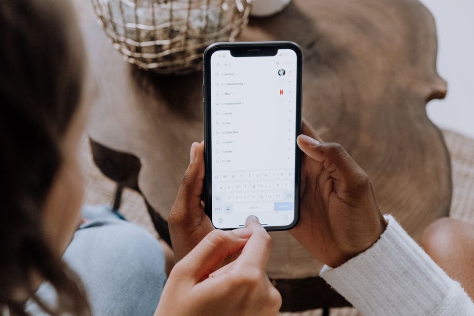 Person using voice search on a smartphone to ask a question