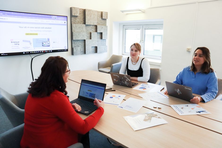 Marketing team reviewing local search results on a laptop