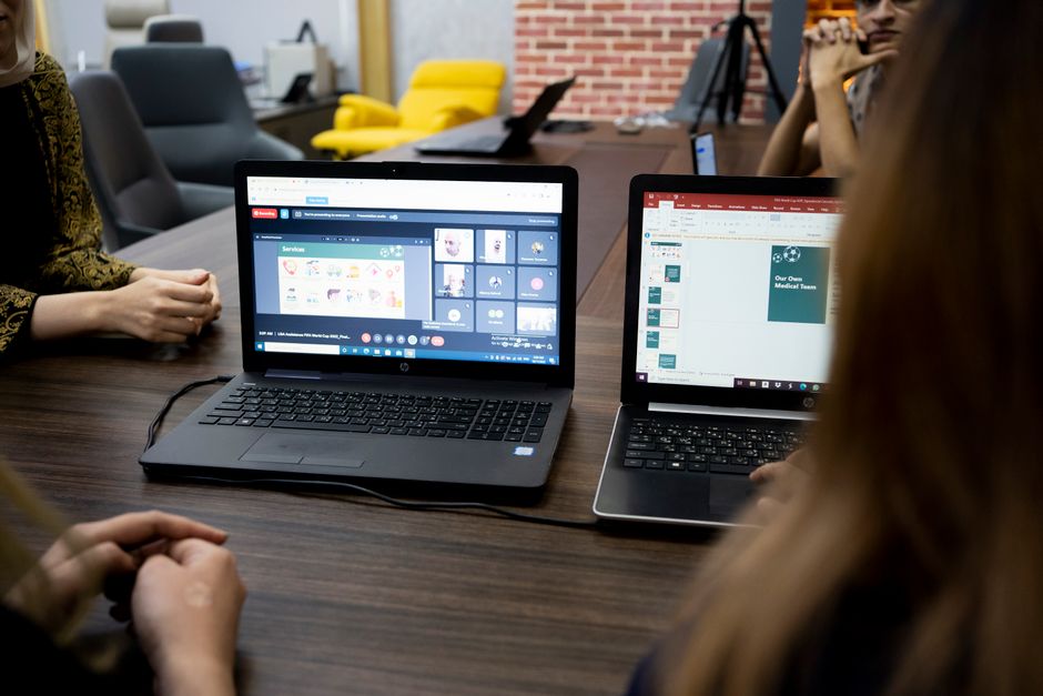 Dubai business team planning a customer chatbot project on a laptop