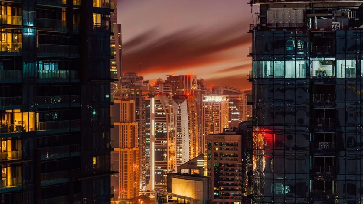 High-rise towers lit at dusk in a dense city business district