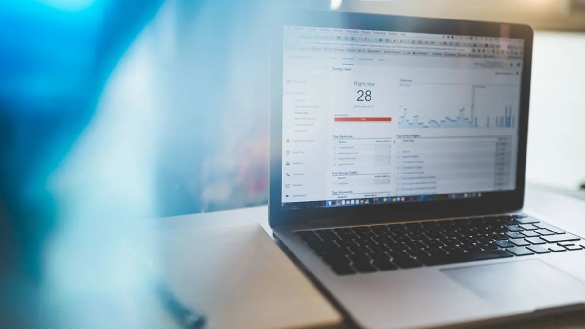 Laptop on a desk showing a web analytics report