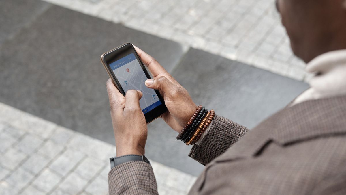 Person checking a map on a smartphone in the city