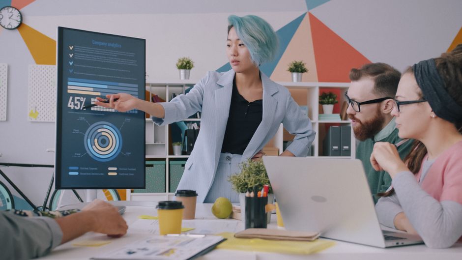 Marketing team reviewing influencer campaign results on a laptop in a modern office