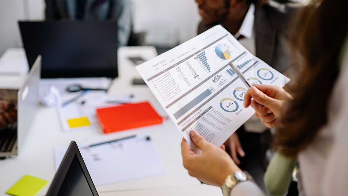 Team reviewing a printed social media performance report in an office