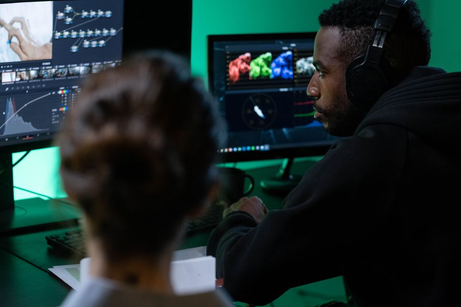 Social media team editing short video content at a workstation