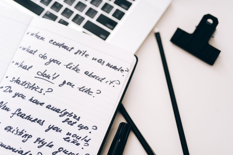 Notebook with content strategy notes beside a laptop on a desk