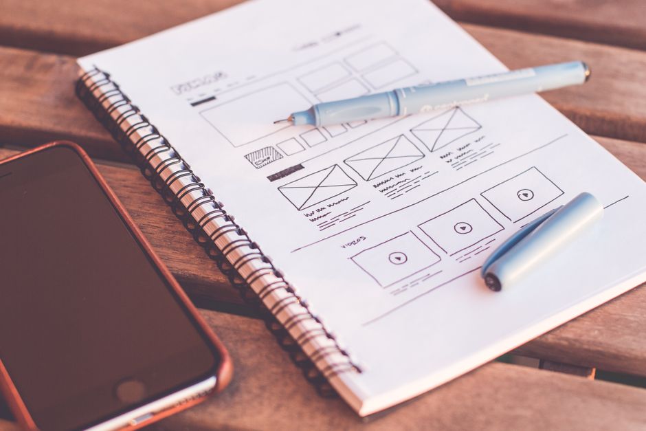 Website wireframe sketched in a notebook