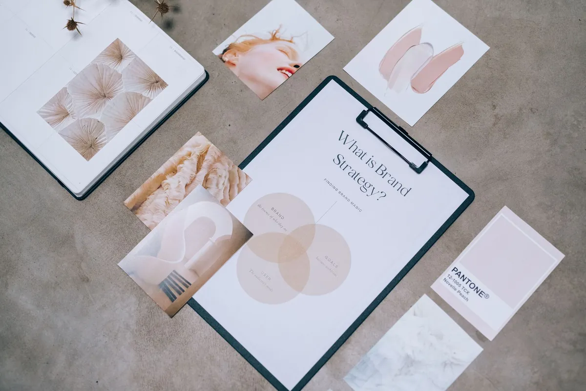 Creative professional reviewing brand identity documents in a workspace