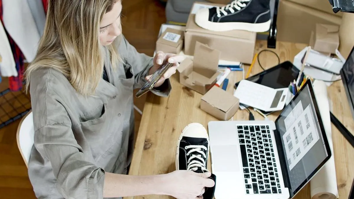 Small business owner working on a laptop inside a shop