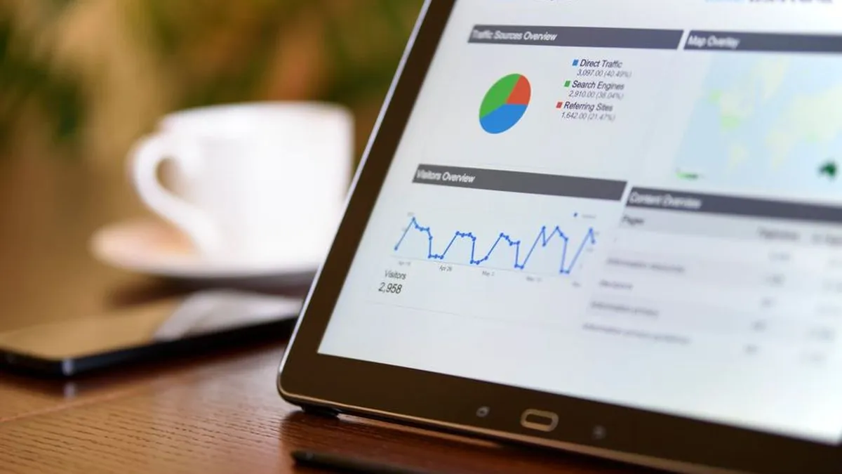 Tablet screen showing a web analytics dashboard with traffic charts