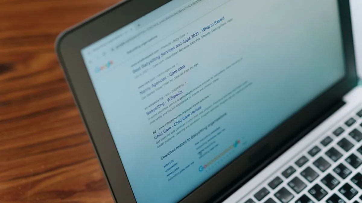 Laptop screen showing a page of search results on a wooden desk
