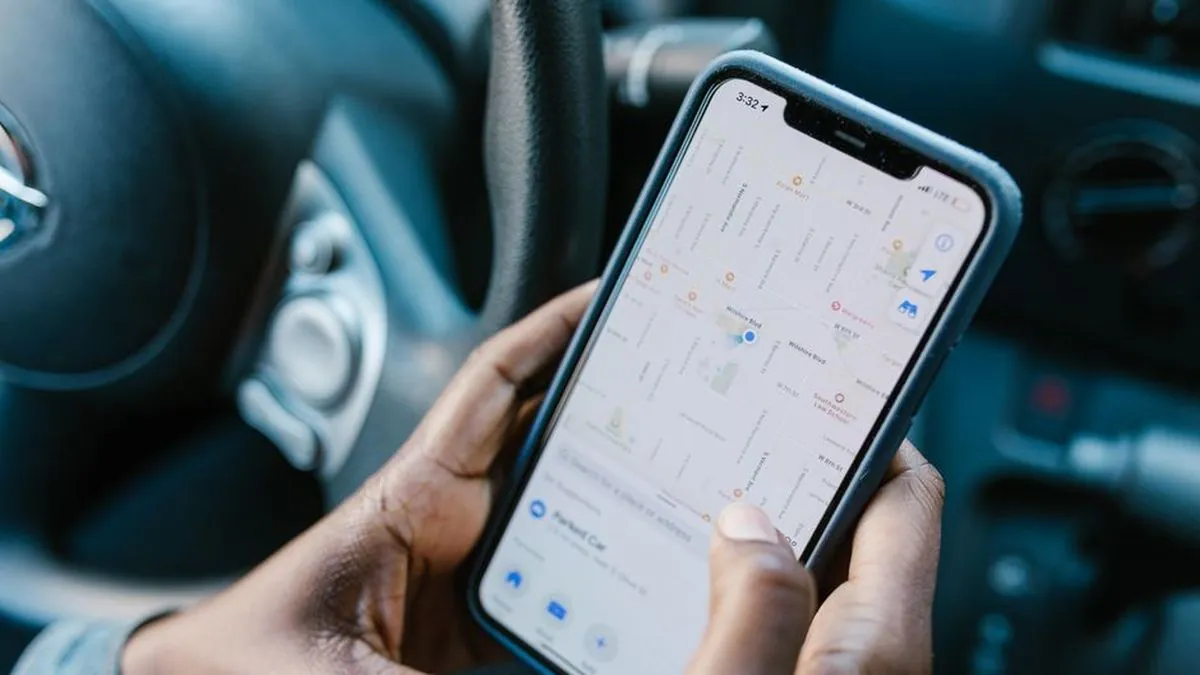 Person holding a smartphone showing a map with business locations