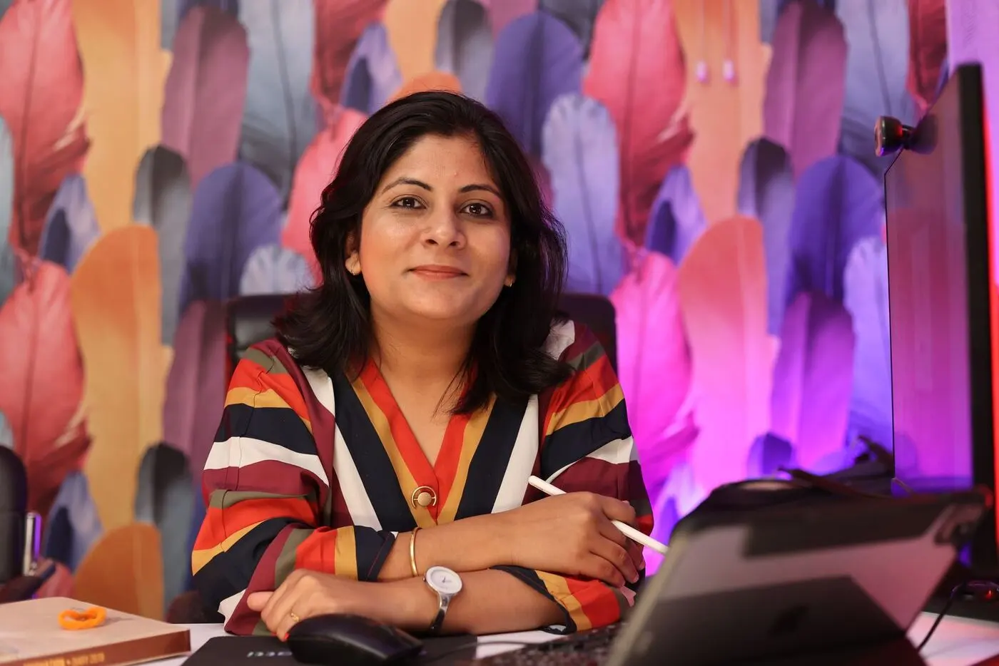 Smiling business owner at her desk with a laptop